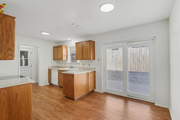 a view of kitchen with granite countertop cabinets and wooden floor