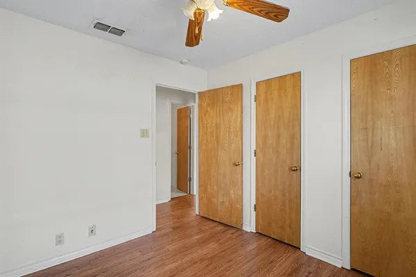 a view of a room with wooden floor