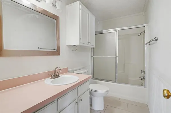 a bathroom with a sink toilet a mirror and shower