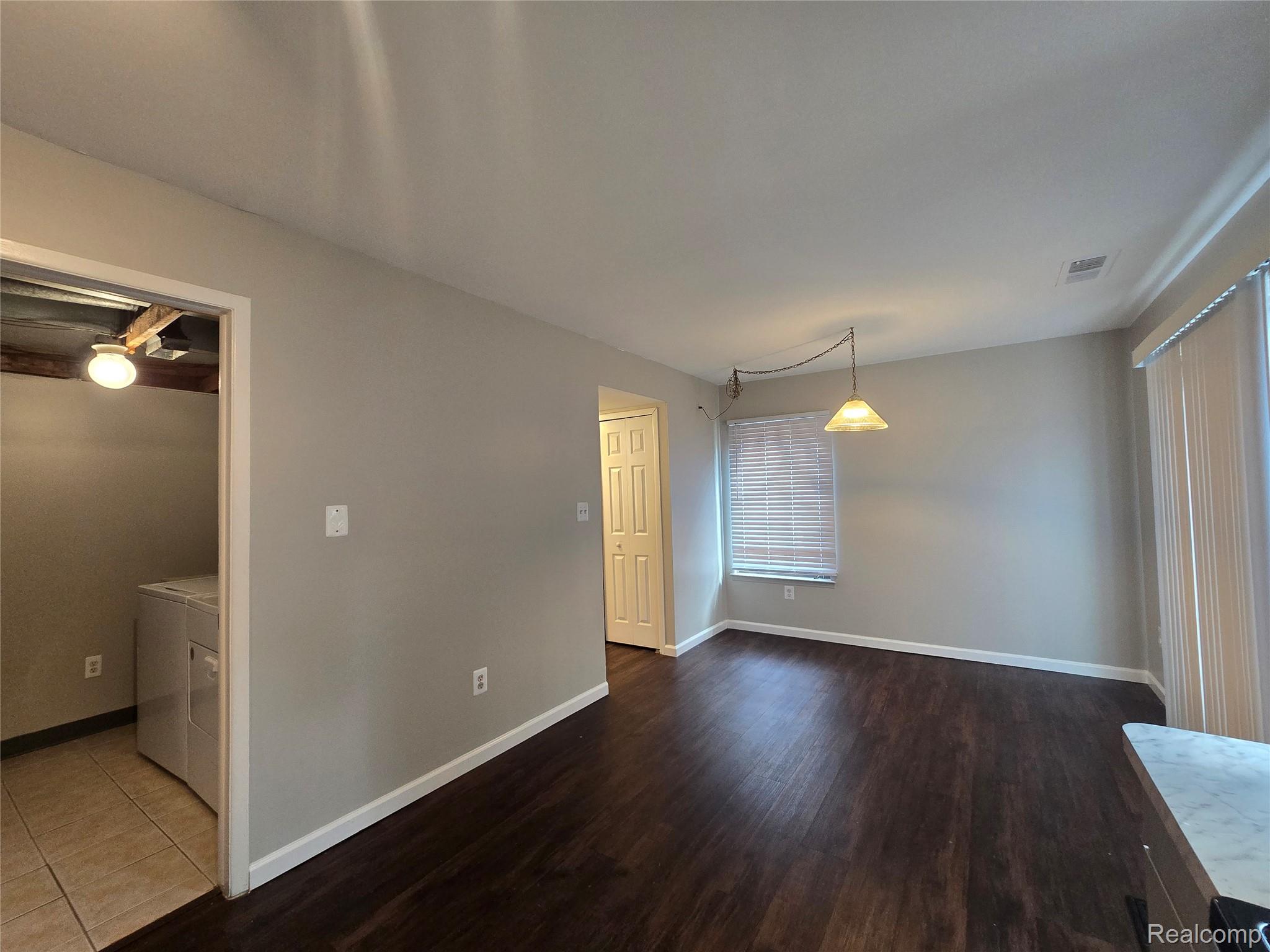 23568 Lahser Road Southfield, MI 48033 - Photo 7 of 18 Rich wood-finish flooring, neutral wall tones, and overhead lighting