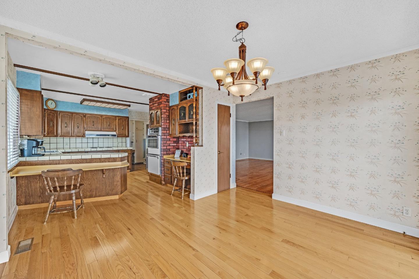 6 Fairview Place Millbrae, CA 94030 - Photo 12 of 19 a view of a room with wooden floor and chandelier