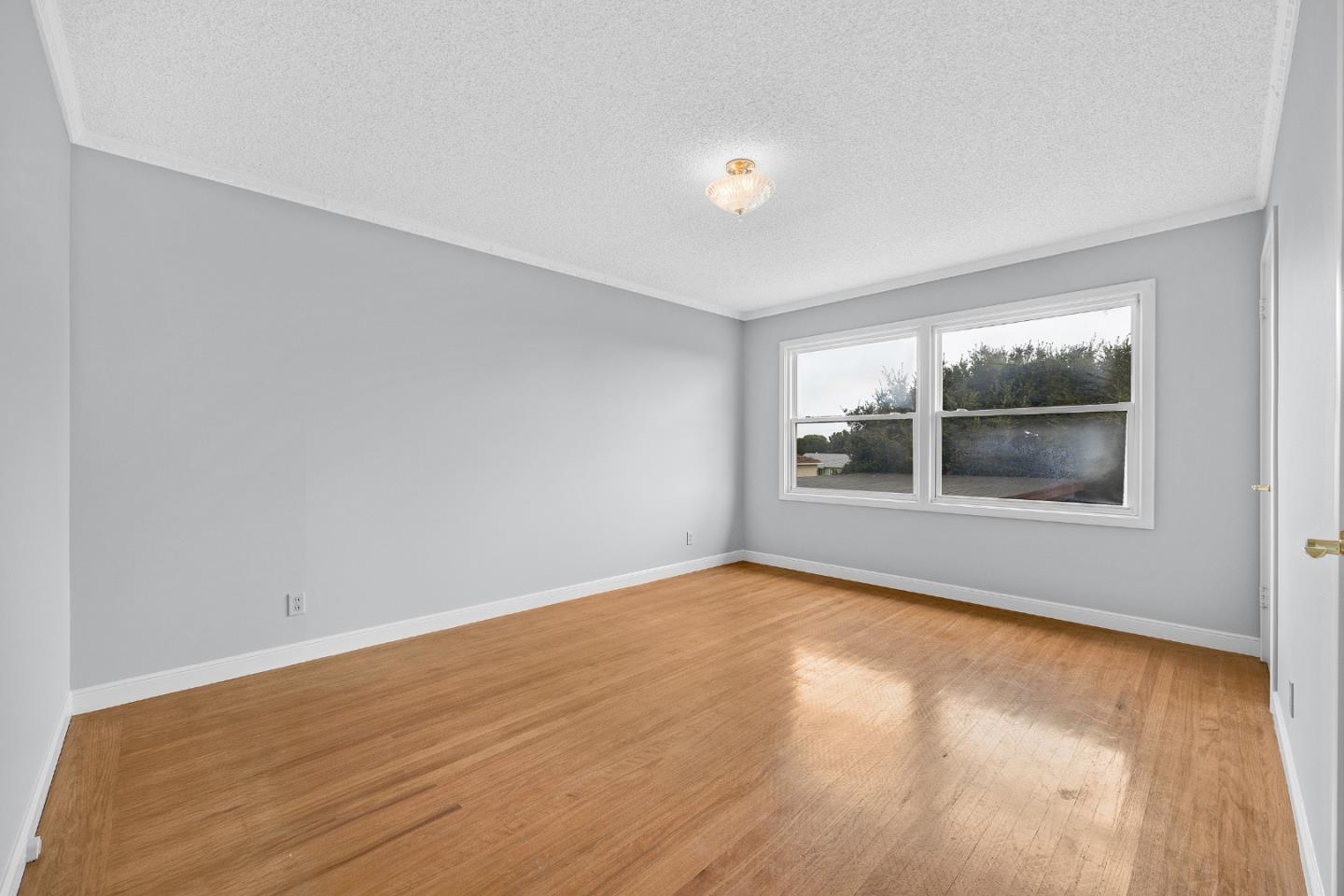 6 Fairview Place Millbrae, CA 94030 - Photo 5 of 19 a view of empty room with wooden floor and fan