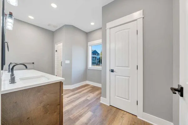 a spacious bathroom with a sink a mirror and a shower