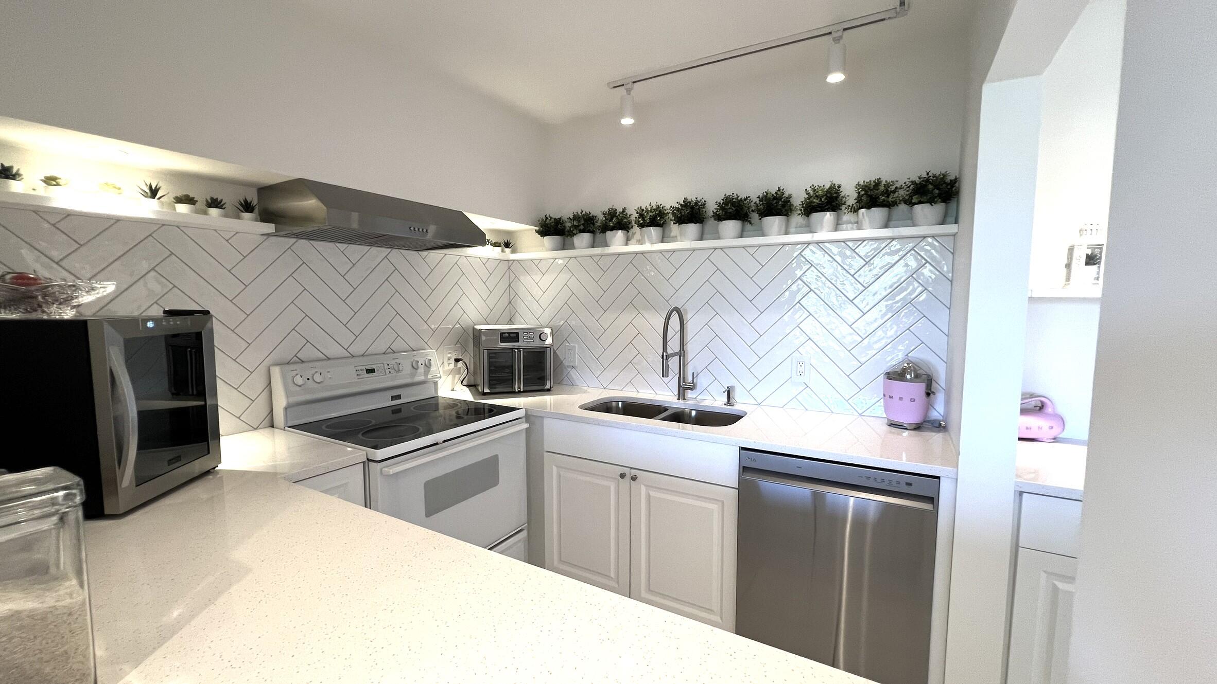 3027 Durham B Deerfield Beach, FL 33442 - Photo 13 of 25 a kitchen with a sink and cabinets