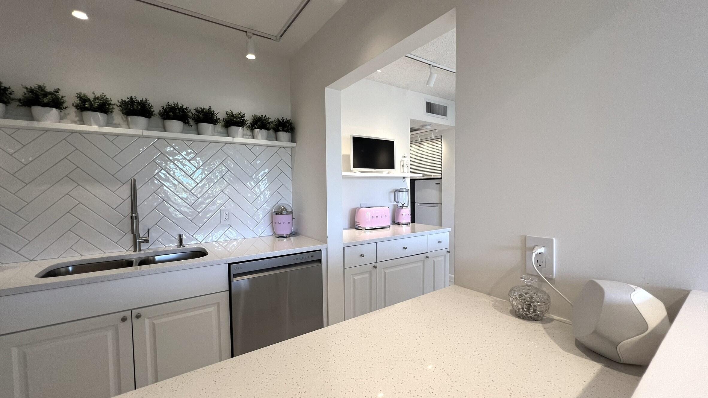 3027 Durham B Deerfield Beach, FL 33442 - Photo 14 of 25 a bedroom with a bed and cabinets