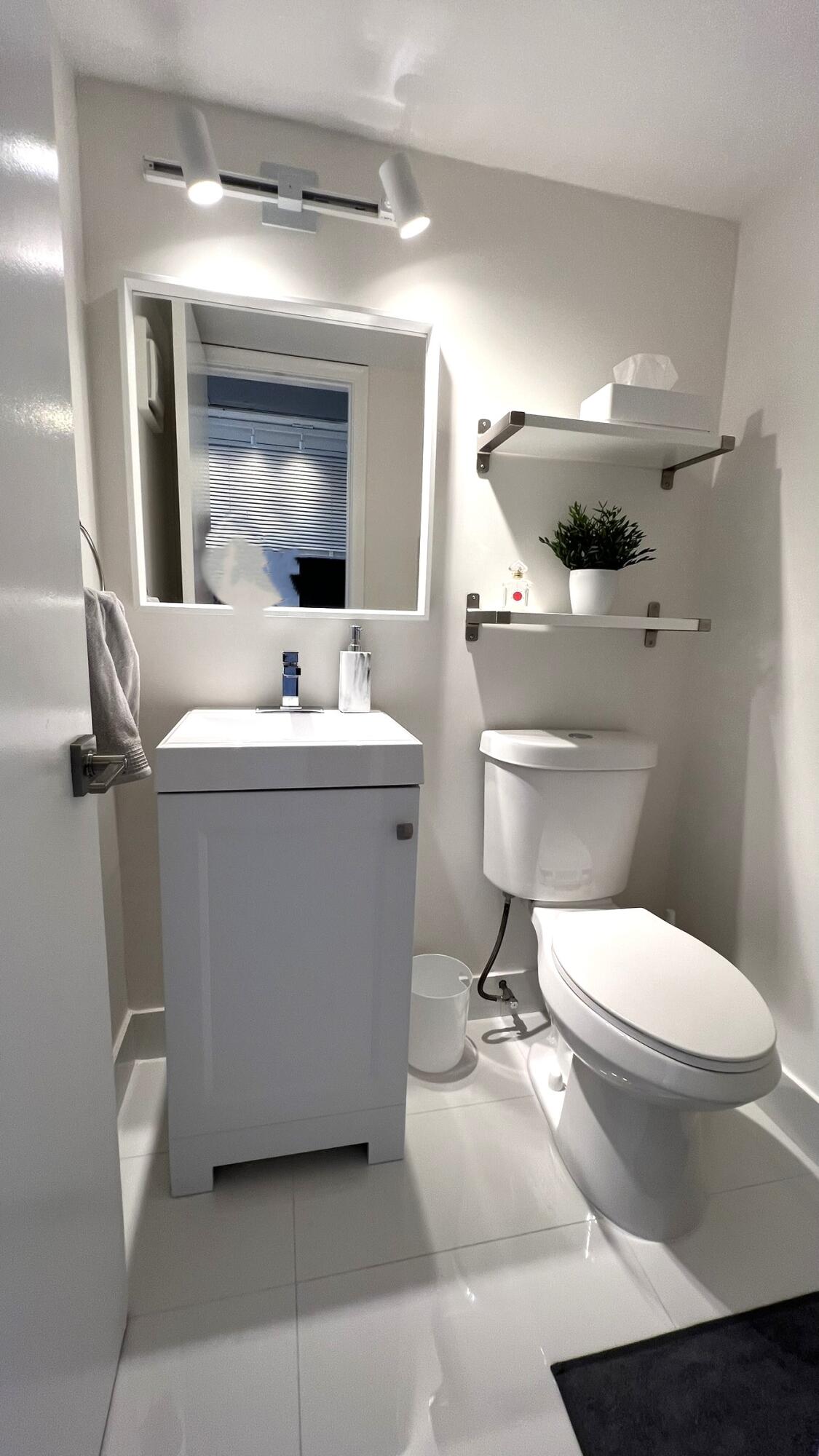 3027 Durham B Deerfield Beach, FL 33442 - Photo 16 of 25 a bathroom with a sink toilet and mirror