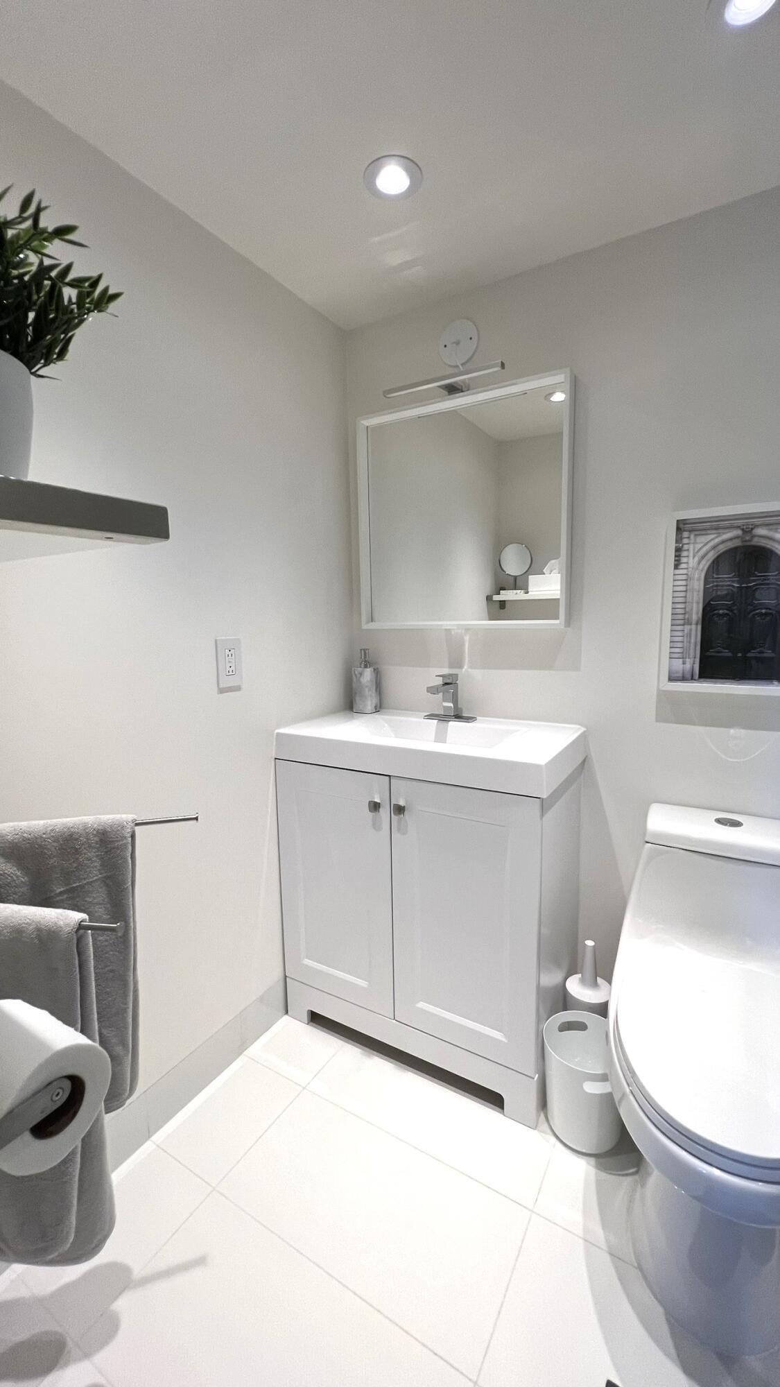 3027 Durham B Deerfield Beach, FL 33442 - Photo 22 of 25 a bathroom with a sink toilet and mirror