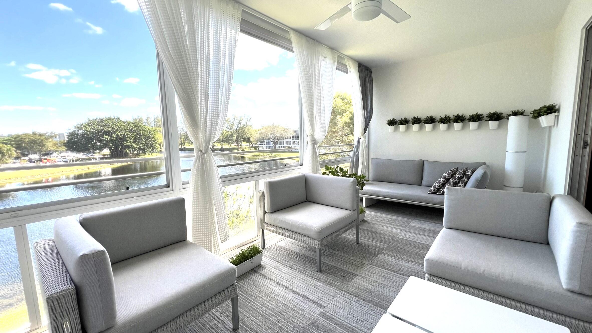 3027 Durham B Deerfield Beach, FL 33442 - Photo 23 of 25 a living room with furniture and a large window