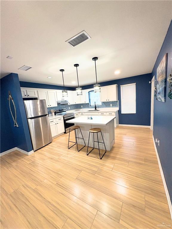 1651 Michigan Avenue Port Isabel, TX 78578 - Photo 4 of 17 a living room with stainless steel appliances furniture a rug and a kitchen view