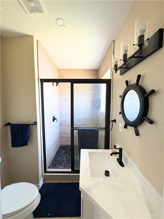 1651 Michigan Avenue Port Isabel, TX 78578 - Photo 8 of 17 a bathroom with a sink mirror vanity and toilet