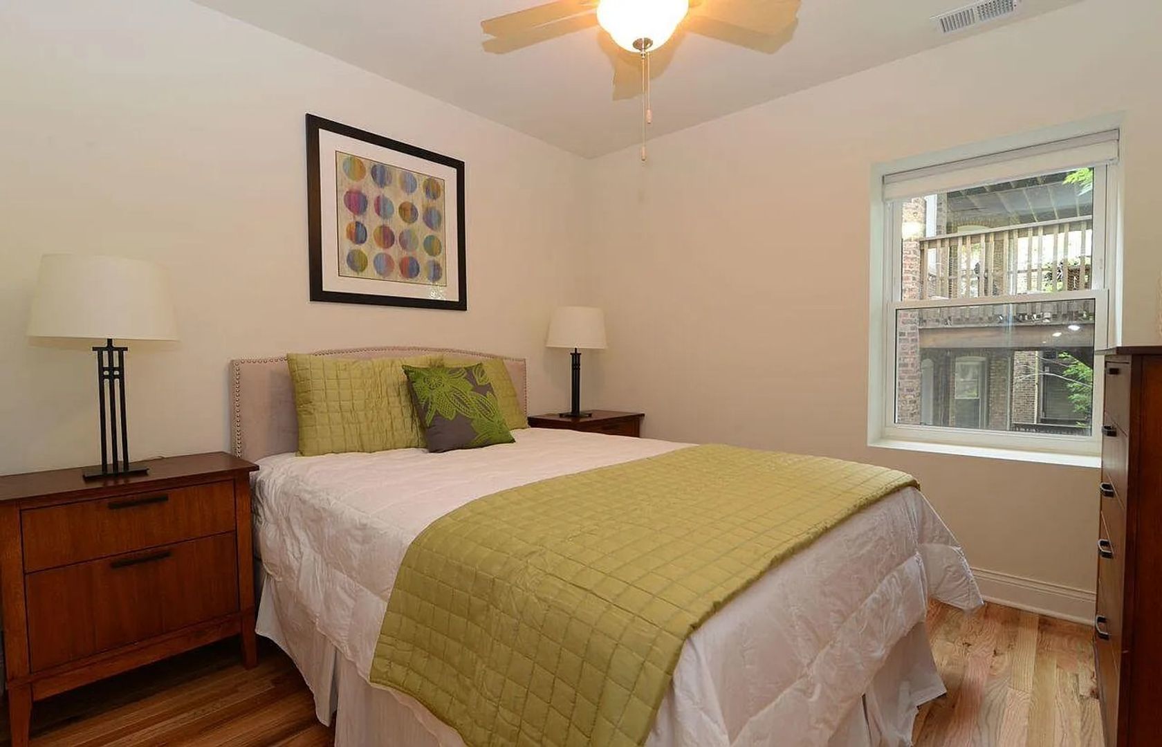 4520 North Beacon Street, Unit 401 Chicago, IL 60640 - Photo 5 of 11 a bedroom with a bed and a window