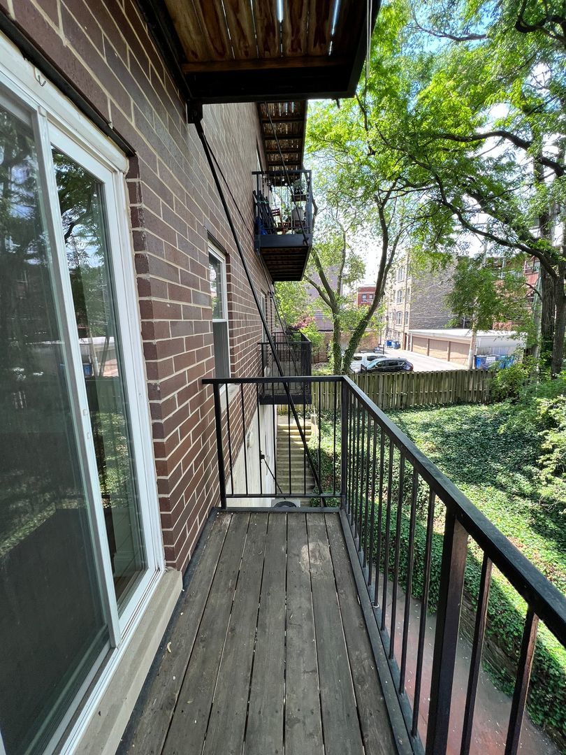 4520 North Beacon Street, Unit 401 Chicago, IL 60640 - Photo 8 of 11 a view of a balcony with wooden floor