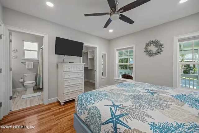 a bedroom with bed and a chandelier