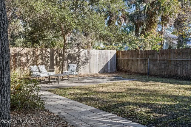 a view of a two chairs in the patio