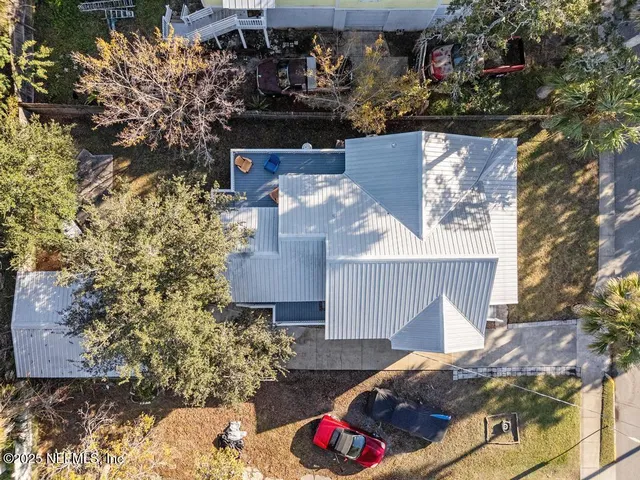 a view of a yard with wooden fence