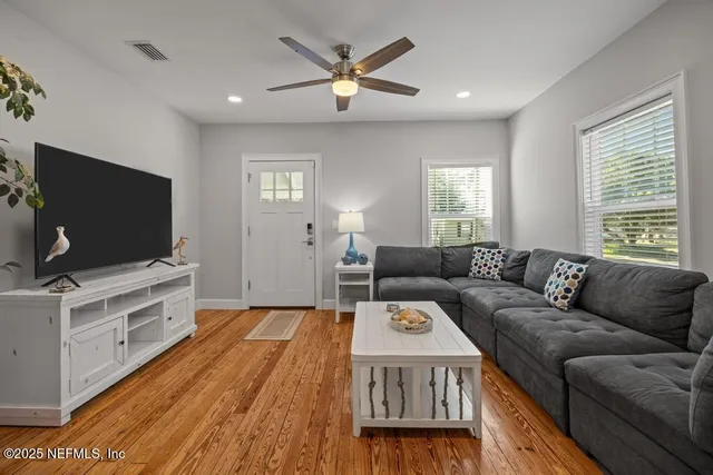 a view of a dining room with furniture wooden floor and a chandelier
