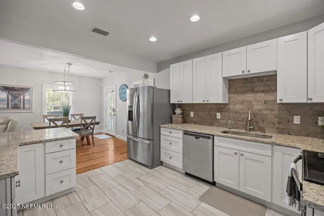 a view of a hallway with washer and dryer