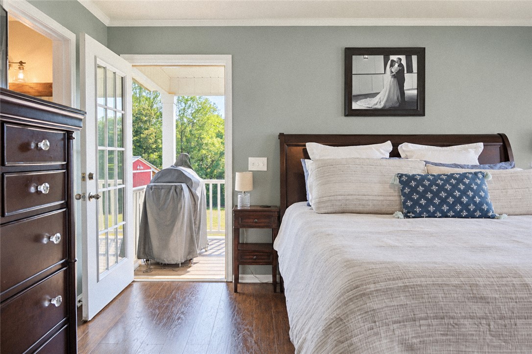2420 Rainey Road Starr, SC 29684 - Photo 15 of 36 Rich hardwood floors anchor this inviting bedroom opening directly onto a private balcony.