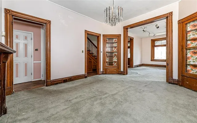 a view of a livingroom with a chandelier & entryway