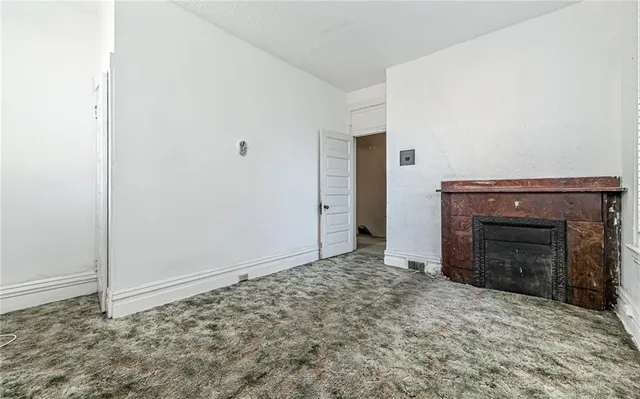 an empty room with a fireplace
