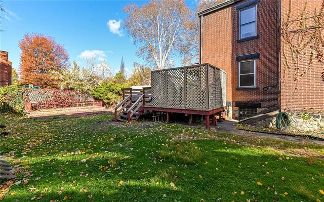 a view of backyard with deck and garden