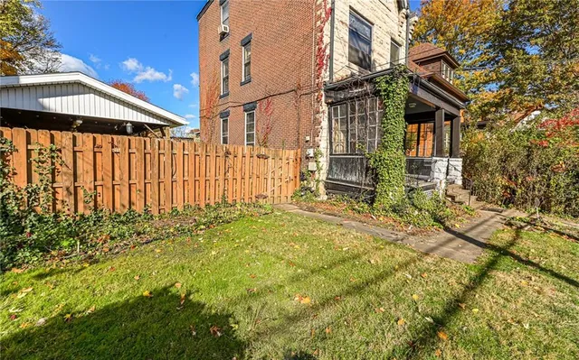 a view of a brick house with large windows