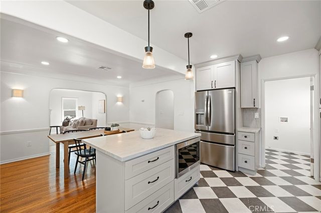 a kitchen with a sink stove top oven and cabinets
