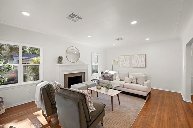 a living room with furniture a fireplace and a clock