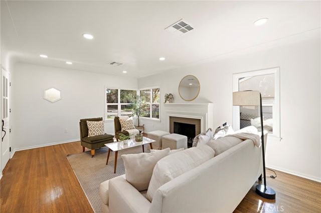 a living room with furniture window and wooden floor