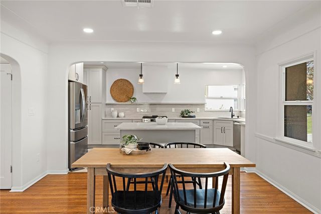 a kitchen with a dining table chairs and window