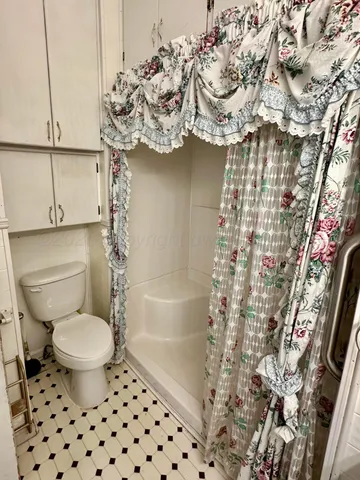 a view of a hallway with a refrigerator