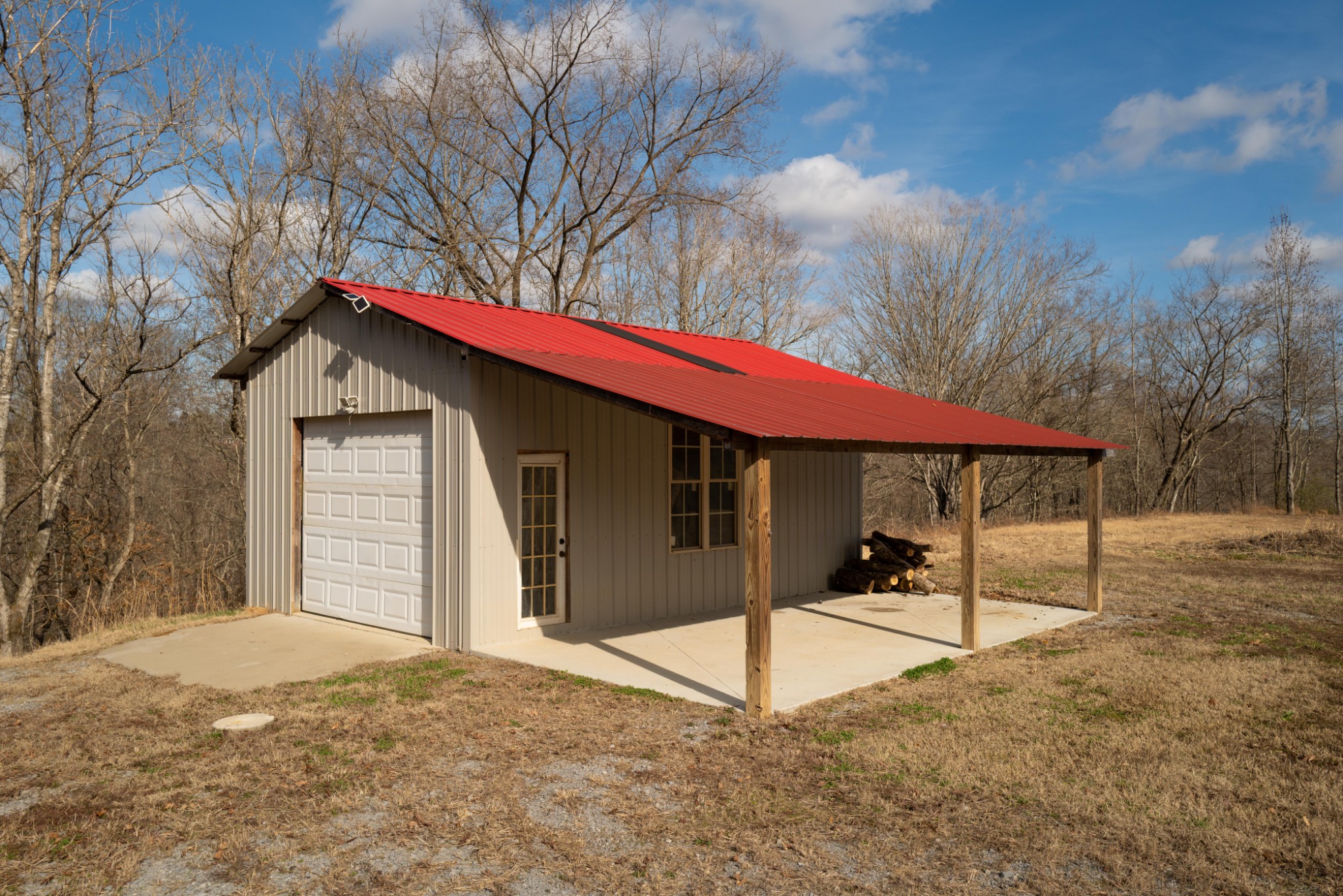 199 Spain Road Charlotte, TN 37036 - Photo 11 of 12 a backyard of a house with table and chairs