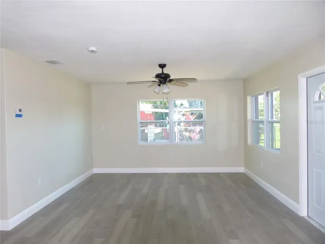 wooden floor in an empty room with a window