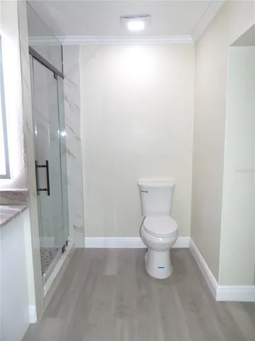 a bathroom with a toilet and a shower
