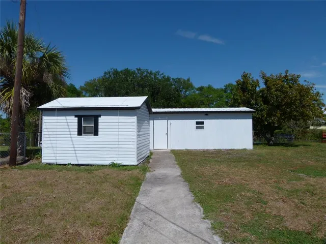 a view of a house with a yard and garage