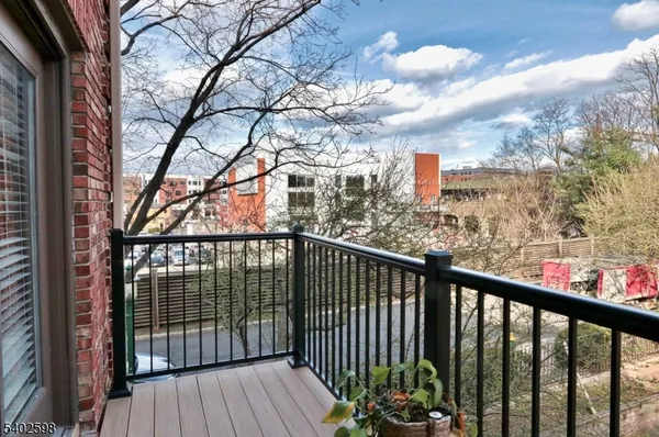a view of a balcony with wooden fence