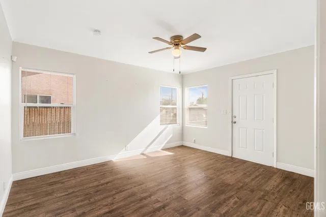wooden floor in an empty room with a window