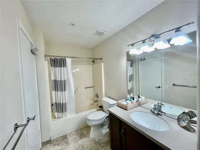 a bathroom with a double vanity sink toilet and shower
