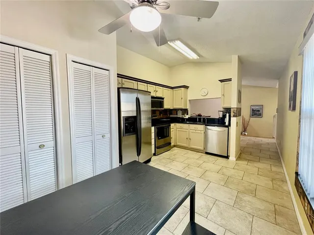 a kitchen with stainless steel appliances a refrigerator and a stove top oven