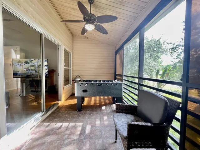 a balcony with furniture and a large window