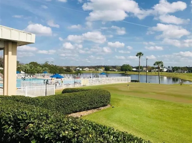 a view of a lake with houses in the background