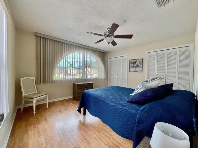 a bedroom with a bed and a chair