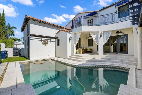 an aerial view of a house with a yard and outdoor seating