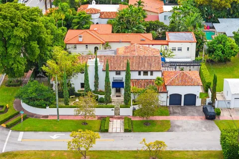 a aerial view of a house with a yard and potted plants