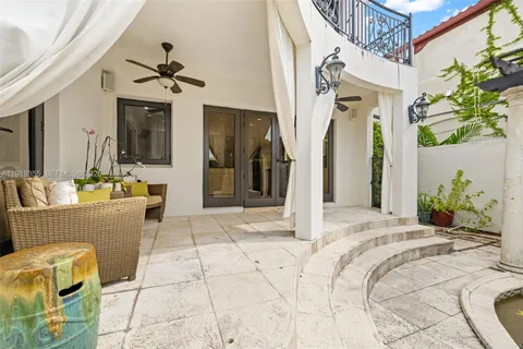 a bedroom with a bed couch and a view of kitchen