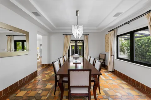 a view of living room filled with furniture and large windows