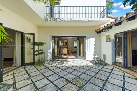 a living room with furniture and large windows