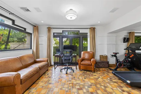 a bedroom with a bed couch and a view of kitchen