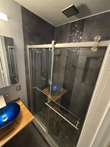 a bathroom with a sink and shower