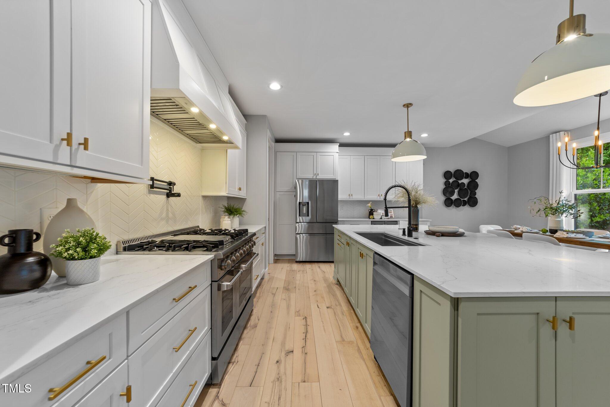 3316 Milton Road Raleigh, NC 27609 - Photo 15 of 50 a kitchen with sink a stove and cabinets
